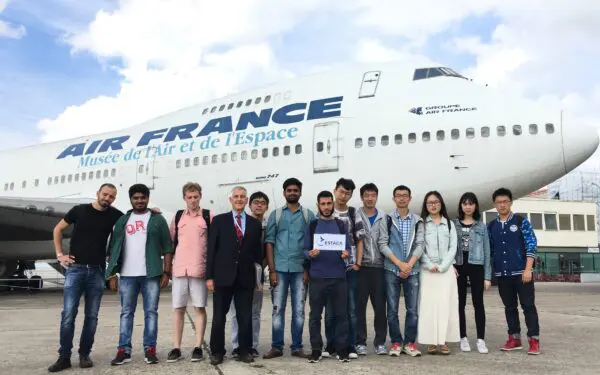 Students in front on an AIRFRANCE plane in Bourget airport.