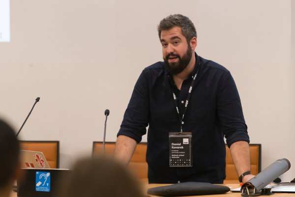 An instructor behind a podium, engaging with attendees